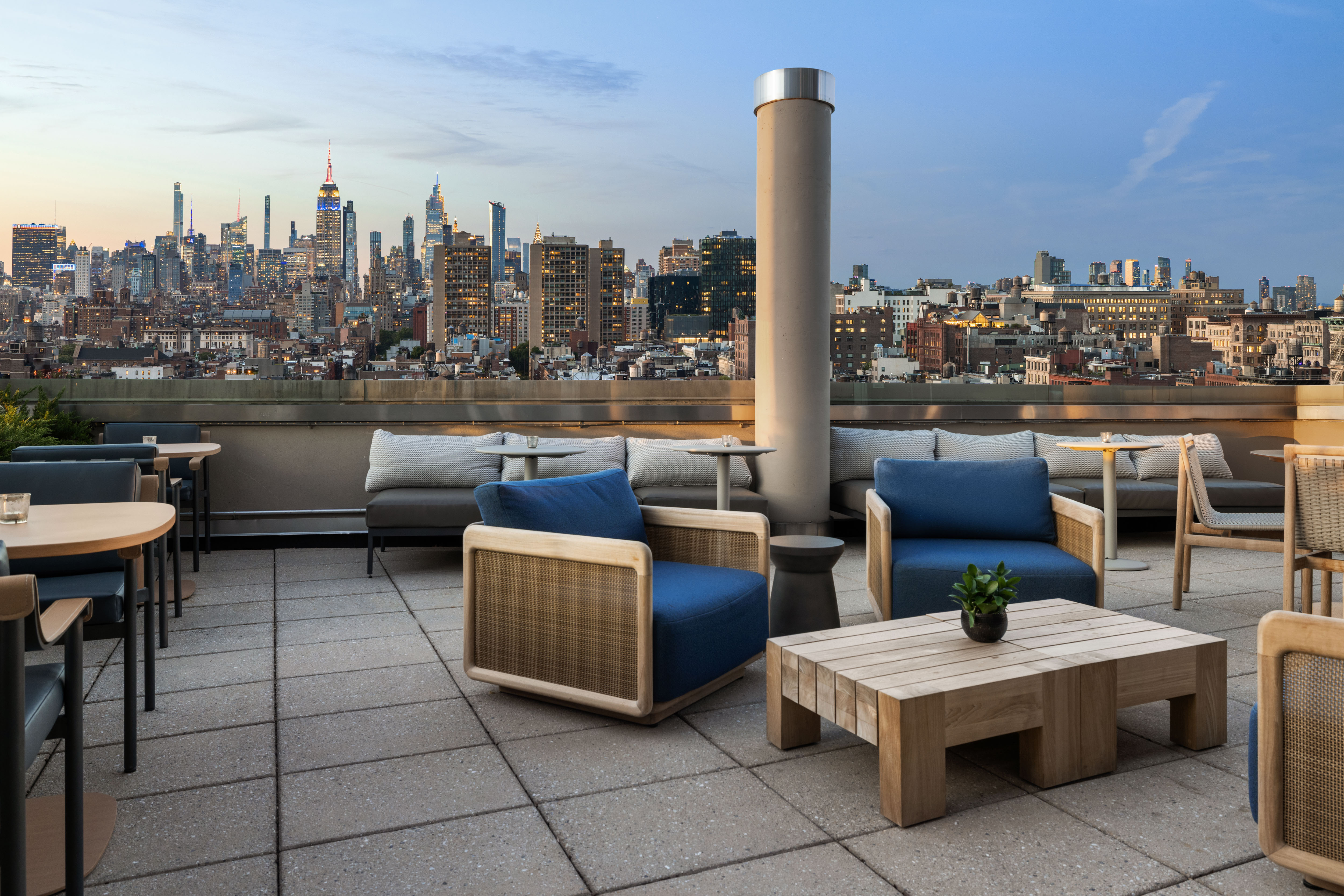 Terrace lounge seating at dusk with New York skyline views at Sheraton Tribeca